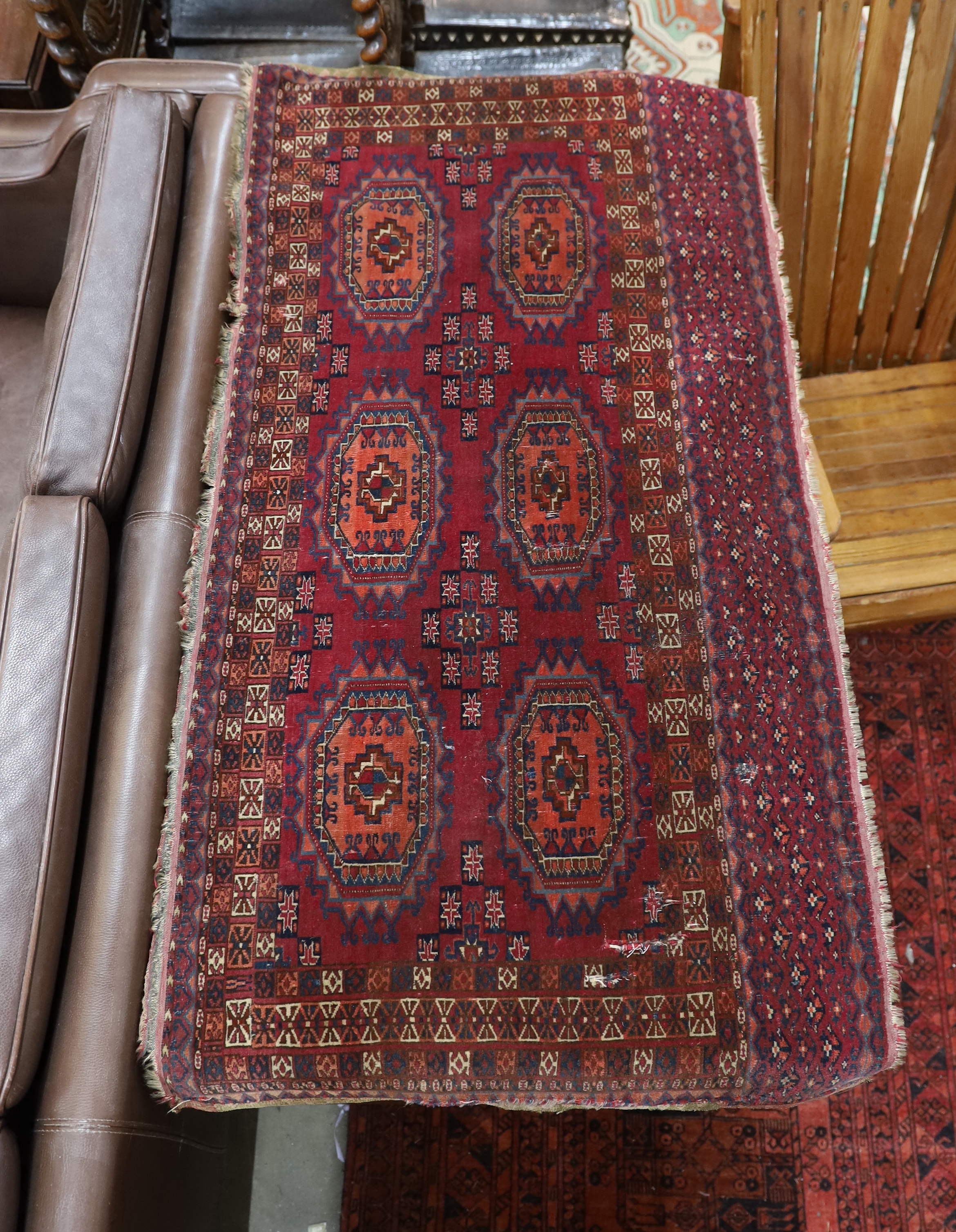 An antique Tekke rug 138cm x 66cm and an Afghan runner 280cm x 104cm.